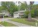 Well-maintained two-story house on a green lawn with mature shade trees at 120 Park Bridge Ln, Roswell, GA 30075