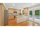 Spacious kitchen with wooden cabinetry, stainless steel appliances, granite countertops and door to outdoor deck at 120 Park Bridge Ln, Roswell, GA 30075