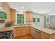 Kitchen featuring wooden cabinets, stainless steel appliances, granite countertops and door to outdoor deck at 120 Park Bridge Ln, Roswell, GA 30075