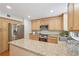 Bright kitchen featuring wooden cabinets, stainless steel appliances, granite countertops, and a center island at 120 Park Bridge Ln, Roswell, GA 30075