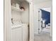 Functional laundry area with washer, dryer, and shelving for storage at 120 Park Bridge Ln, Roswell, GA 30075