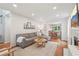 Open-concept living room showcases hardwood floors, a gray sectional sofa, recessed lighting and a view to the dining area at 120 Park Bridge Ln, Roswell, GA 30075