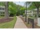 Private bridge to park with a landscaped walkway and mature trees at 120 Park Bridge Ln, Roswell, GA 30075