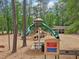 A colorful playground featuring slides, towers, swings and benches, providing fun for children at 120 Park Bridge Ln, Roswell, GA 30075