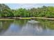Scenic pond featuring a fountain and surrounded by trees at 120 Park Bridge Ln, Roswell, GA 30075