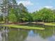 Peaceful pond surrounded by lush trees and greenery at 120 Park Bridge Ln, Roswell, GA 30075