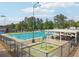 An outdoor swimming pool surrounded by a fence, trees, and a covered area, providing recreation and relaxation at 120 Park Bridge Ln, Roswell, GA 30075