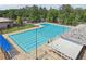Aerial view of an outdoor pool with marked lanes, poolside furniture, and a covered seating area for recreation at 120 Park Bridge Ln, Roswell, GA 30075