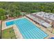 Overhead view of an outdoor pool with marked lanes, a kiddie pool, and surrounding trees for recreation at 120 Park Bridge Ln, Roswell, GA 30075