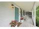 Cozy front porch with seating, flowers, and decorative details at 120 Park Bridge Ln, Roswell, GA 30075