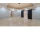 Finished basement with open floor plan, tray ceiling, recessed lighting, and large barn doors at 1720 Buckhead Valley Ne Ln, Atlanta, GA 30324