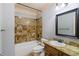 Bathroom with colorful tile surround, shower-tub combo, and vanity at 1720 Buckhead Valley Ne Ln, Atlanta, GA 30324