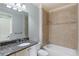 Well-lit bathroom boasts granite counters, tiled shower, and vanity with ample storage at 1720 Buckhead Valley Ne Ln, Atlanta, GA 30324