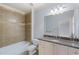 Bathroom features granite counter, tiled shower and decorative tiled accent at 1720 Buckhead Valley Ne Ln, Atlanta, GA 30324