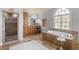 Bright bathroom showcasing a soaking tub, walk-in shower, and custom vanity with ample storage at 1720 Buckhead Valley Ne Ln, Atlanta, GA 30324