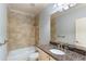 Bathroom featuring granite countertop, tile backsplash, and shower-tub combo at 1720 Buckhead Valley Ne Ln, Atlanta, GA 30324