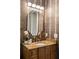 Elegant powder room features a decorative mirror, granite countertop, and textured wallpaper for a sophisticated look at 1720 Buckhead Valley Ne Ln, Atlanta, GA 30324