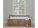 Close-up of the elegant bathtub with tile surround and large window providing natural light at 1720 Buckhead Valley Ne Ln, Atlanta, GA 30324