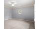 Bright bedroom with oval window and neutral carpet and walls at 1720 Buckhead Valley Ne Ln, Atlanta, GA 30324