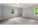 Spacious carpeted bedroom with crown molding and natural light from two windows at 1720 Buckhead Valley Ne Ln, Atlanta, GA 30324