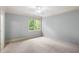 Comfortable carpeted bedroom with crown molding and a window offering scenic outdoor views at 1720 Buckhead Valley Ne Ln, Atlanta, GA 30324