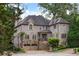 Stunning two-story brick home featuring a stone foundation and a two-car garage with an immaculately landscaped front yard at 1720 Buckhead Valley Ne Ln, Atlanta, GA 30324