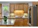 Close-up view of the kitchen with stainless steel appliances and a granite countertop island with breakfast bar at 1720 Buckhead Valley Ne Ln, Atlanta, GA 30324