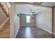 Spacious basement area with wood-look flooring, a ceiling fan, window, and staircase at 20 Spruce Ne St, White, GA 30184