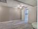 Finished basement with wood-look flooring, a ceiling fan, neutral walls, and access to the bathroom at 20 Spruce Ne St, White, GA 30184