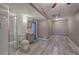 The updated bathroom features a glass shower, toilet and sink and adjoins a bonus room at 20 Spruce Ne St, White, GA 30184
