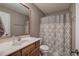 Cozy bathroom with a single sink, toilet, framed mirror and a shower curtain with an ornamental pattern at 20 Spruce Ne St, White, GA 30184
