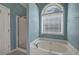 Bathroom featuring a jacuzzi soaking tub and a walk-in shower at 20 Spruce Ne St, White, GA 30184