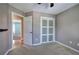 Bedroom featuring grey walls, carpet, a closet with sliding doors and an open doorway to another room at 20 Spruce Ne St, White, GA 30184