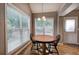Bright breakfast nook features a round table, windows, and views of the backyard at 20 Spruce Ne St, White, GA 30184