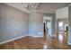 Bright dining room features hardwood floors, chandelier, and open access to other rooms at 20 Spruce Ne St, White, GA 30184