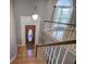 Open foyer with hardwood floors, staircase with white railings, and a decorative chandelier at 20 Spruce Ne St, White, GA 30184