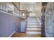 Inviting entryway featuring hardwood floors, staircase with white railings, and a decorative glass front door at 20 Spruce Ne St, White, GA 30184