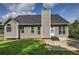 Rear view of the house shows a patio area and well-maintained gray siding at 20 Spruce Ne St, White, GA 30184