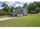 Beautiful two-story home with a manicured lawn and a two-car garage surrounded by lush trees at 20 Spruce Ne St, White, GA 30184