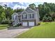 Inviting two-story home with stone accents, gray siding, well-kept lawn, and a convenient two-car garage at 20 Spruce Ne St, White, GA 30184