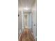 Hallway with hardwood floors leads to bathroom and bedrooms at 20 Spruce Ne St, White, GA 30184