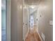 A hallway with hardwood floors connecting different rooms, featuring recessed lighting and white trim at 20 Spruce Ne St, White, GA 30184