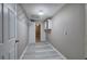 Neutral hallway with storage cabinets and wire shelving, leading to additional spaces at 20 Spruce Ne St, White, GA 30184