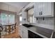 Open-concept kitchen features a breakfast nook, stainless steel sink, and tile backsplash at 20 Spruce Ne St, White, GA 30184