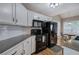 Modern kitchen features white cabinets, black appliances, and tile backsplash at 20 Spruce Ne St, White, GA 30184