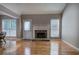 Comfortable living room featuring hardwood floors, a stone fireplace, and large windows at 20 Spruce Ne St, White, GA 30184