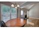 Cozy breakfast nook features a round table, fireplace, and views of the backyard at 20 Spruce Ne St, White, GA 30184
