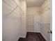 Walk-in closet with carpeted floors and metal storage shelves at 20 Spruce Ne St, White, GA 30184