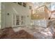 Back of house with brick wall, patio area, wooden porch, and a few small trees at 2729 Ridge Valley Nw Rd, Atlanta, GA 30327
