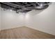 Spacious basement featuring wood floors, white painted walls, and black ceiling with exposed duct work at 2729 Ridge Valley Nw Rd, Atlanta, GA 30327